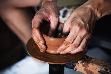 Close up male hands making pottery.