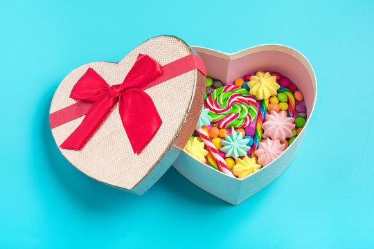 mix colorful chocolate sweets lie in gift box shape of heart on brigth background Flat lay Top view Place for text Holiday card Happy birthday party, Happy Valentine's day, Mother's day concept