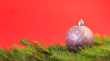 Christmas composition Christmas decorations, fir branches with a red background. Flat design, side view, copy space.