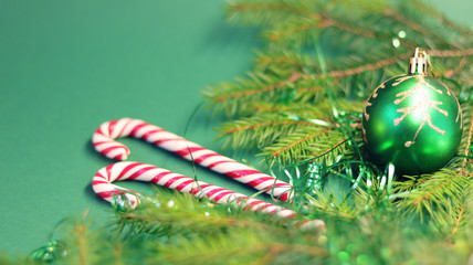  Christmas card with spruce and holiday decorations, sweets, on a green background. Christmas template for banner, ticket, brochure, card, invitation, poster, etc.