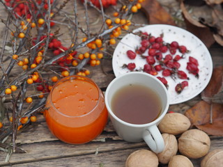 rowan-sea-buckthorn branches and sea-buckthorn jam on a wooden background