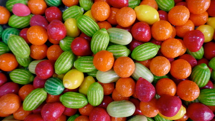 Delicious fruit sweets.  Colorful fruit dragees, oranges, melons, cherries, lemons, with soft filling. Close-up.