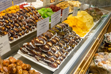Eastern desserts displayed on sweets shelves for sale
