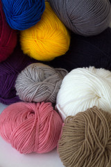 colorful wool balls of yarn on white background