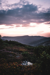 Sunset behind the mountains in national park Krkonose, Czech Republic
