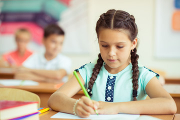 Children studying in classroom at the school