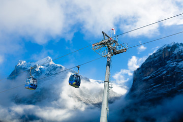 Cable car with ski slope in mountains near Switzerland. Swiss Alps train and ski lift.