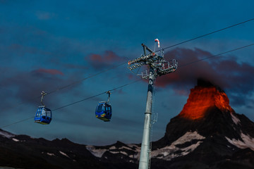 Beautiful mountains in winter, ski lifts, skiers and snowboarders traveling, Italy, Alps