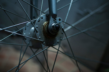 Fototapeta na wymiar Grey rusted spokes of a antique bicycle.