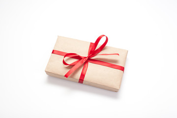 Gifts isolated on white background, Packed in brown paper and decorated with red ribbon with bow, there is room for lettering. Concept surprises and gifts for loved ones.