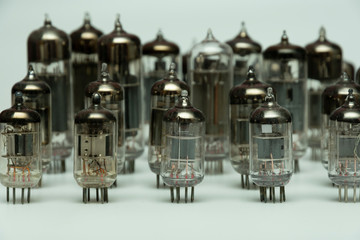 different vintage vacuum lamps for electronic amplifiers, audio players and tube TVs on a white...