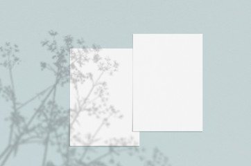 Blank white vertical paper sheet 5x7 inches with shadow overlay. Modern and stylish greeting card or wedding invitation mock up.