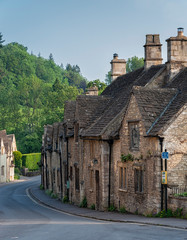 Fototapeta na wymiar CASTLE COMBE, COTSWOLDS, UK - MAY 26, 2018: Typical and picturesque English countryside cottages in Castle Combe Village, Cotswolds, Wiltshire, England - UK