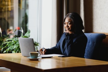 happy young african american businesswoman using computer in office