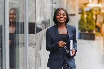 portrait of young african businesswoman standing outdoors - Powered by Adobe
