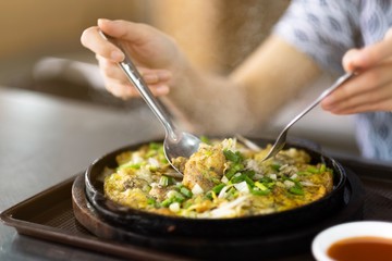 seafood omelet in hot pan ,street food in bangkok