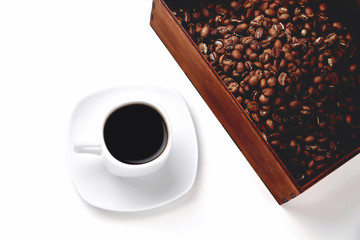 white cup of coffee on a white saucer, natural wooden box with coffee beans on a white background, isolate,  angle view from above top