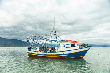 Naklejka na ściany i meble Fishing boat in Paraty Bay World Heritage in Rio de Janeiro, Brazil
