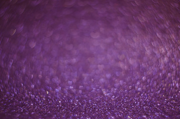 Abstract New Year purple bokeh background with shining defocus sparkles. Blurred glitters shimmering dust macro close up, copy space for text logo