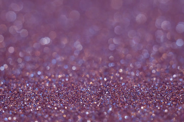 Abstract festive pink bokeh background with shining defocus sparkles. Blurred glitters shimmering dust macro close up, copy space for text logo