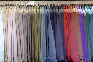 Close up of Multi colored shirts on hangers, Colorful apparel cloth background