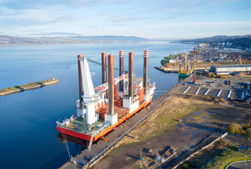 Barge ship crane construction at dock harbour in the sea ocean aerial view from above of...