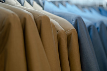 Fototapeta premium Close up of luxurious style gentlemen suit on hangers