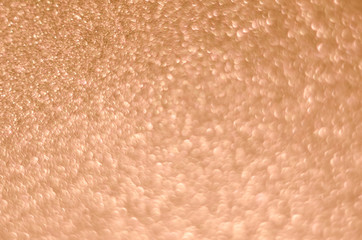 Abstract New Year coral bokeh background with shining defocus sparkles. Blurred glitters shimmering dust macro close up, copy space for text logo