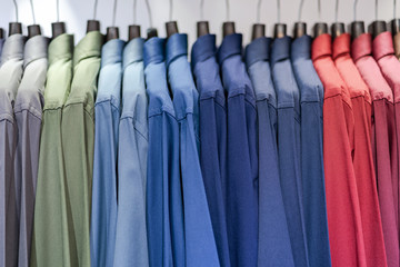 Close up of Multi colored shirts on hangers, Colorful apparel cloth background
