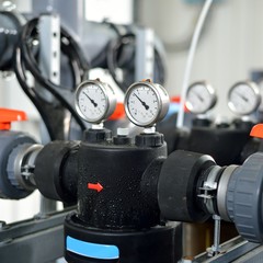 industrial barometers and water pipes in boiler room