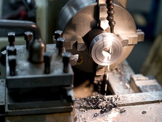 Old metal lathe machine, retro machine background.