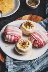 Bacon-wrapped button mushrooms stuffed with cheese