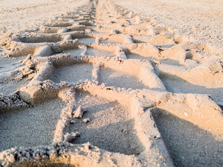 tractor tire prints on sand at a construction site  
