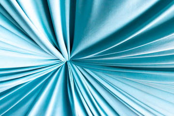 Turquoise natural draped woven fabric with soft pleats, background