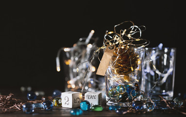 Beautiful Christmas background with  block calendar and glowing Christmas lights in a glass jar.