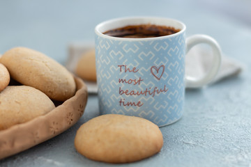 A mug of coffee on a table with delicious homemade cookies.
