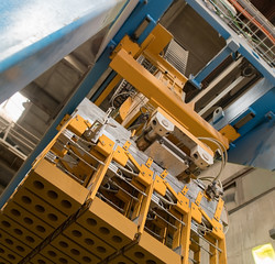 Bottom view of production machine with bricks