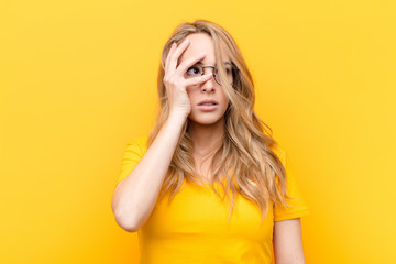 young pretty blonde woman feeling bored, frustrated and sleepy after a tiresome, dull and tedious...