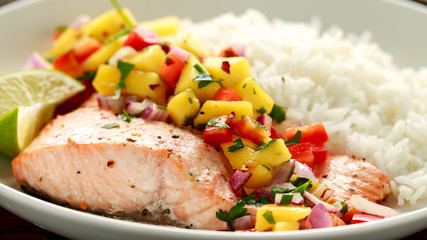 Salmon with mango salsa and white rice on plate