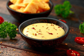 Homemade Cheese Sauce with spice on wooden table