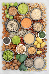 Vegan health food for fitness & a healthy planet concept with sustainable foods high in protein, vitamins, minerals, omega 3, antioxidants, smart carbs & fibre. Flat lay, top view.