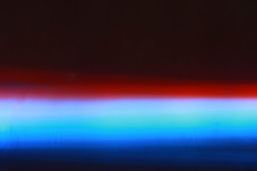 Glowing neon red and blue sticks. Blurred background.
