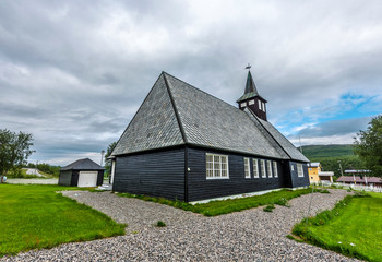 Fototapeta na wymiar Black wooden church in Masi village in Norwegian Finnmark.