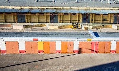 Warehouse industrial premises. Loader standing behind. View from outdoors.