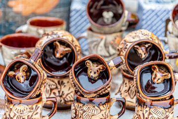 Fototapeta na wymiar Porcelain souvenir mugs with mouse figures inside as symbols of the ancient Russian city of Myshkin