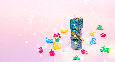 Gift boxes on pink background with confetti. New Year holidays concept. Copy space