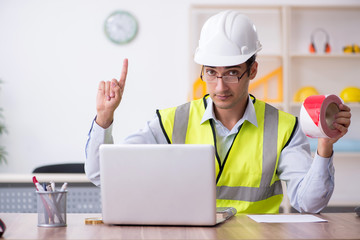 Young male architect working in the office