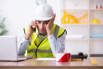 Young male architect working in the office