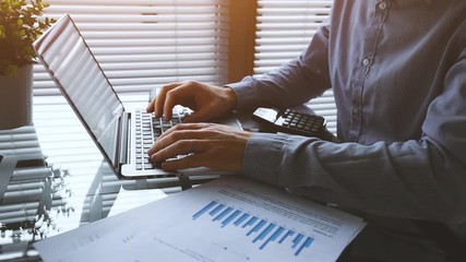 financial plan or marketing strategy, hands of business man working with charts and laptop computer in office