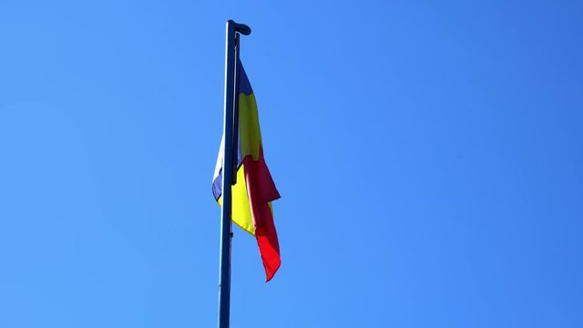Romanian Flag in the Wind with Blue Sky Background, Romania Flag with Blue Yellow Red Colors